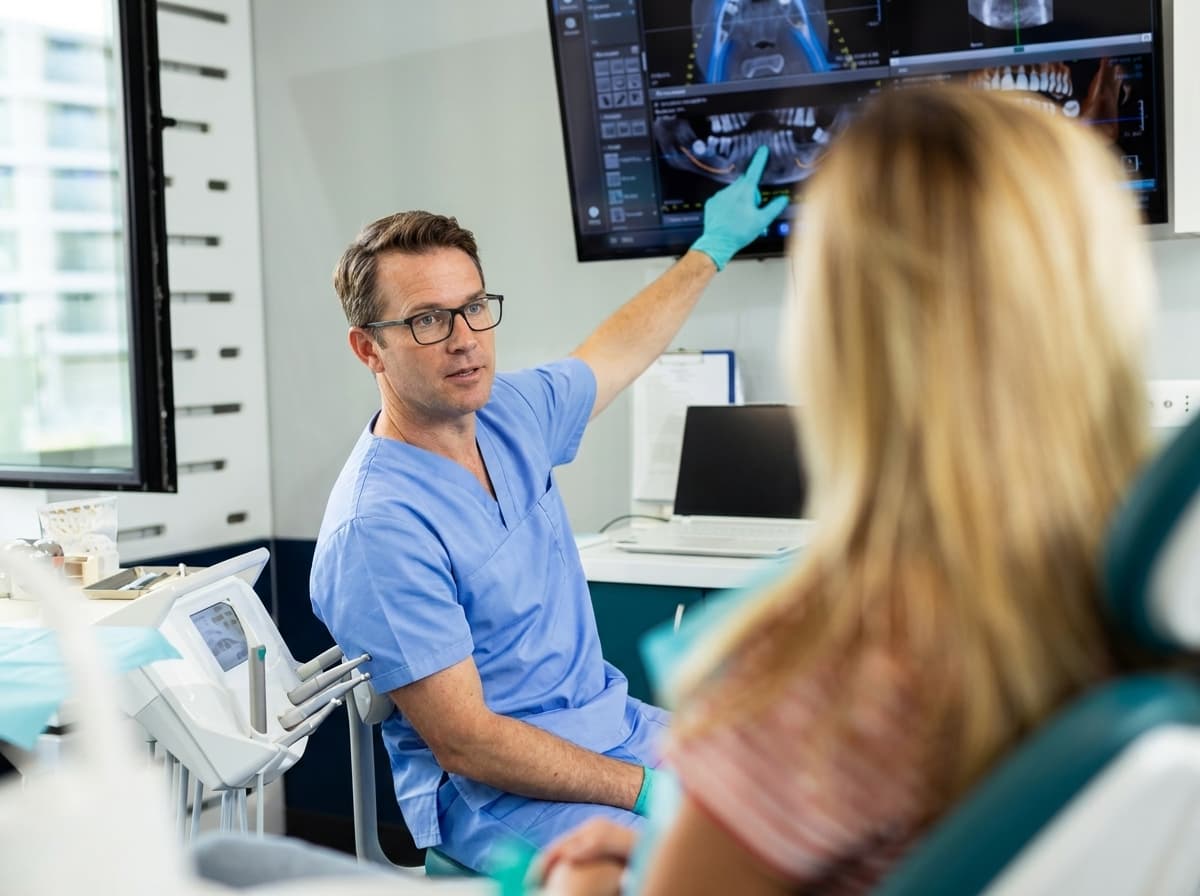 Dentist explaining a dental X-ray to a patient